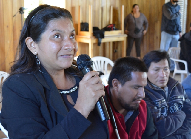 Una mujer con discapacidad visual habla con un micrófono junto a otras personas